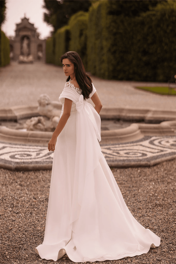 Ivory Off - the - Shoulder Wedding Dress with Thigh Slit – Trumpet Gown with Flower Adorned Neckline and Cascading Bow Plus Size - WonderlandByLilian