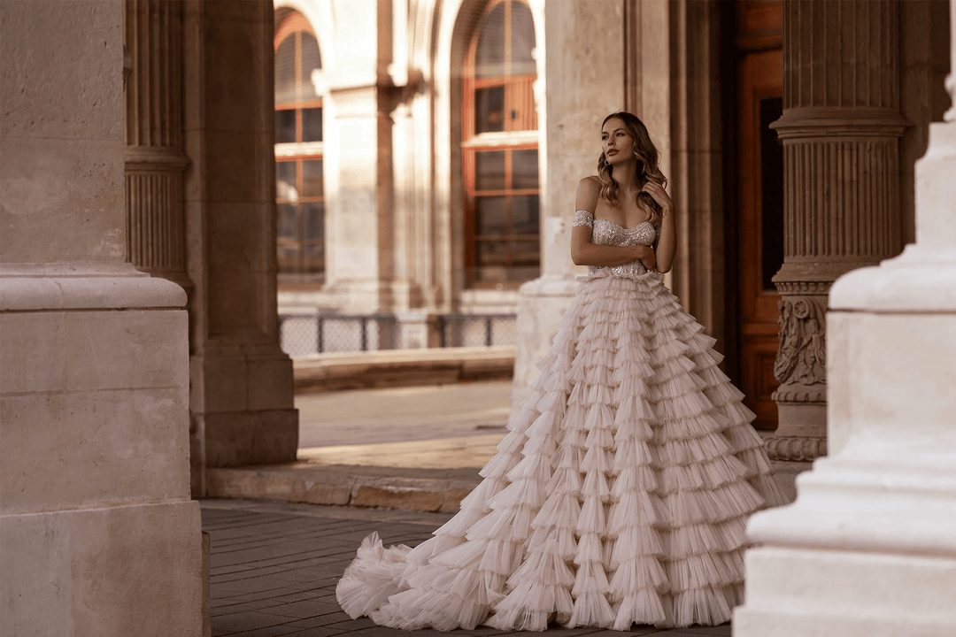 Off Shoulder Wedding Dress with Ruffled Tiered Skirt – Layered Tulle Ruffle Dress with Pearl Trim and Crisscross Back Plus Size - WonderlandByLilian